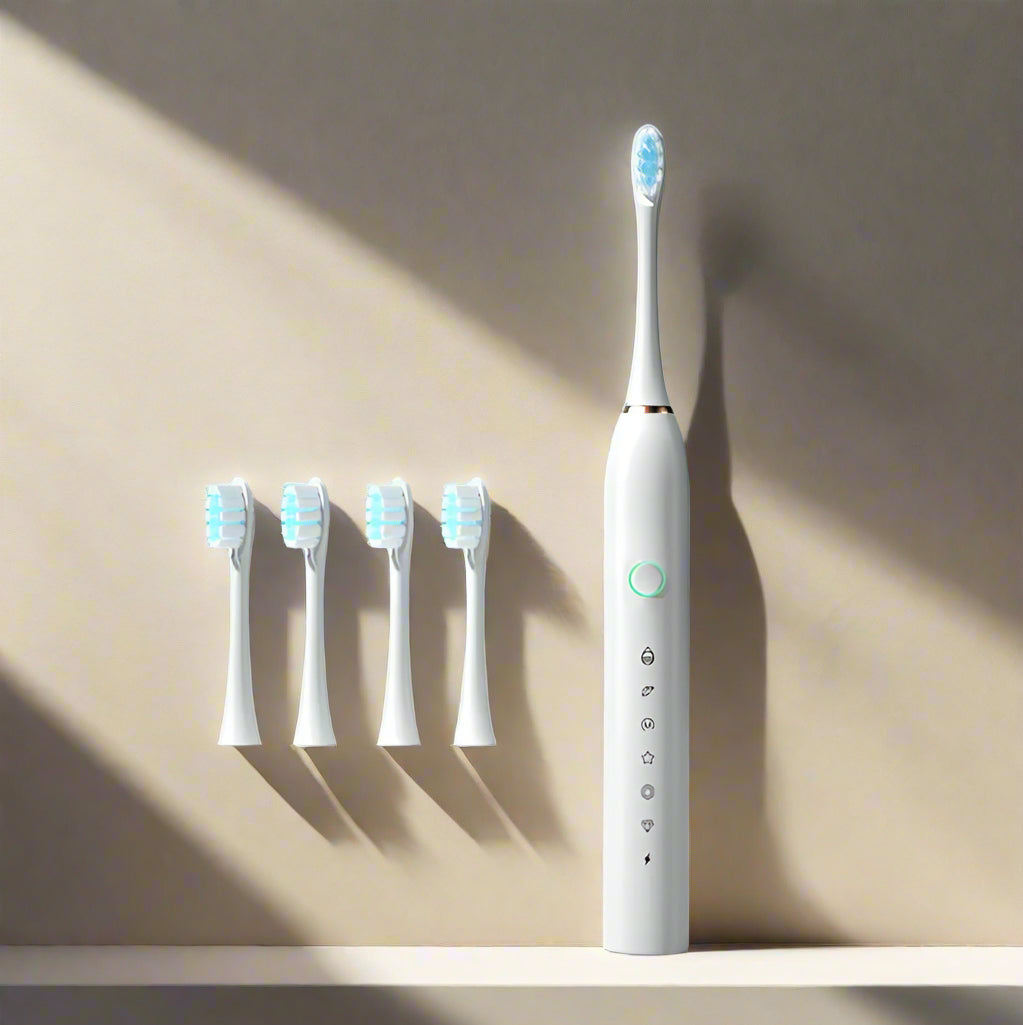 White electric toothbrush with four special brush heads on a light blue background